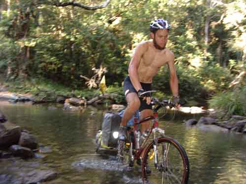 Tim, cycling across a creek