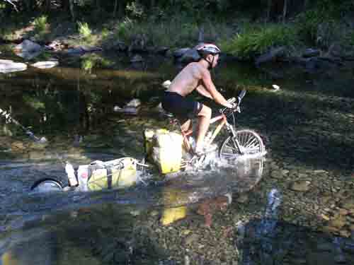 Dan, cycling across a creek
